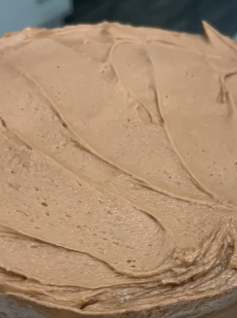 chocolate cream cheese frosting on a huge cake
