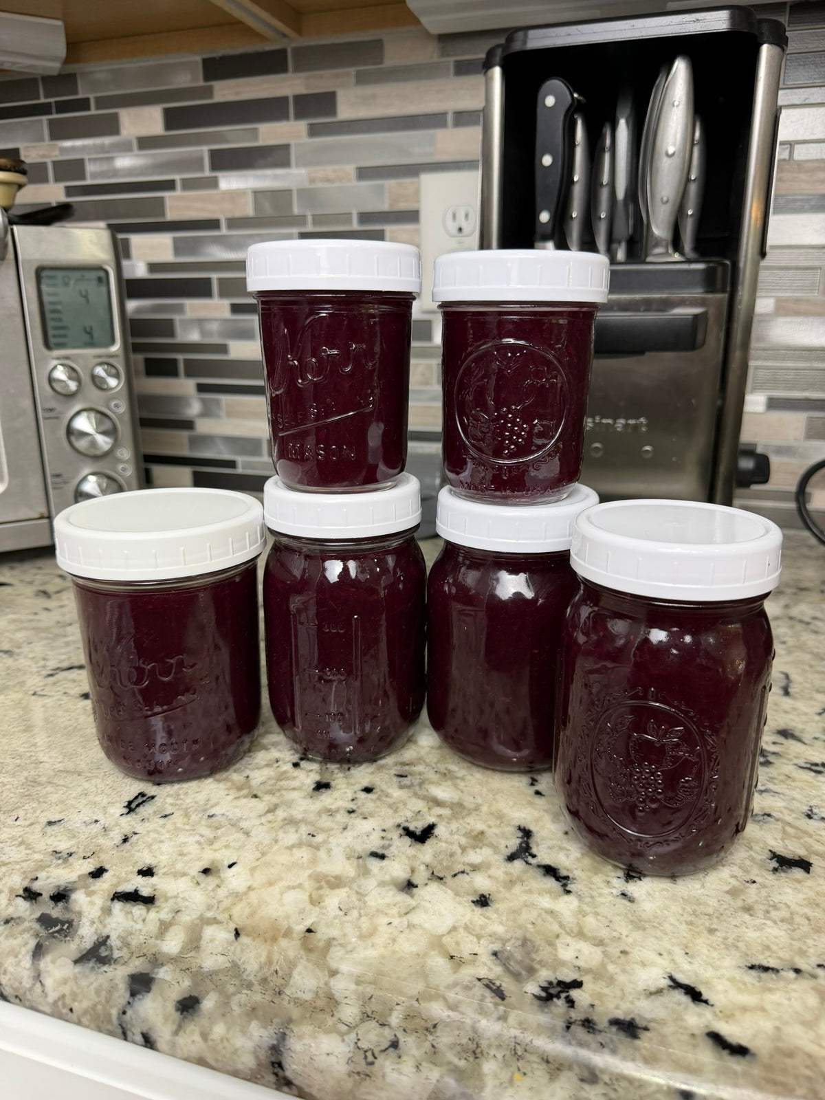 grape freezer jam in jars with white lids 