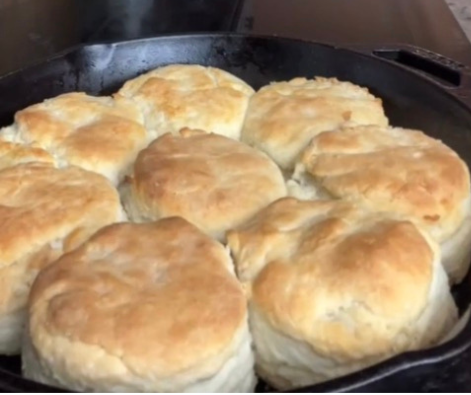 Freshly baked homemade Southern lard biscuits with golden tops cooked in a cast iron pan